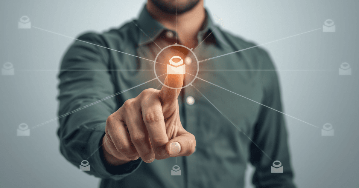 Man in a charcoal gray shirt pointing at a glowing AI hub icon connected to network automation workflow icons, symbolizing network automation software technology.